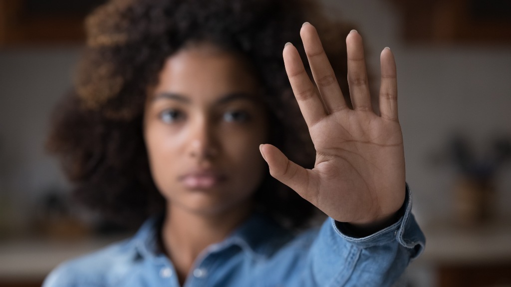 woman show palm hand opposes discrimination, make stop gesture