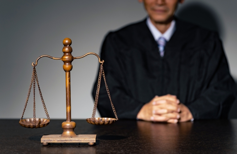 A man in a robe and a scale