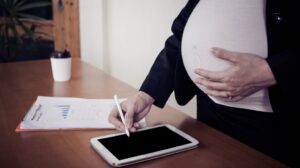 Pregnant woman working on tablet