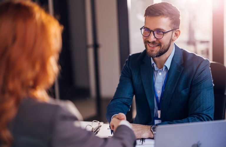 Happy lawyer shaking hands with a client