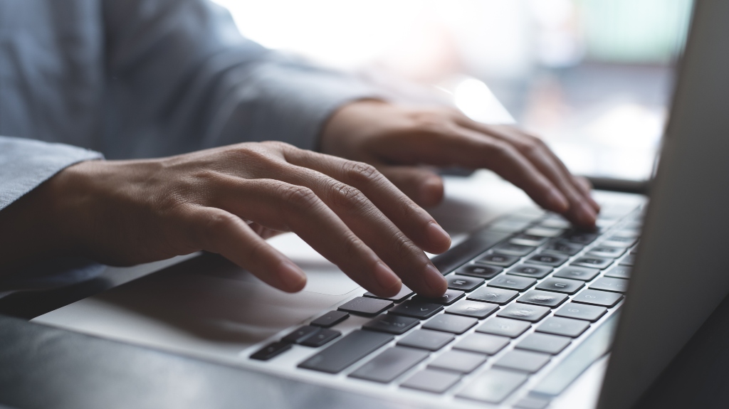 woman typing on laptop