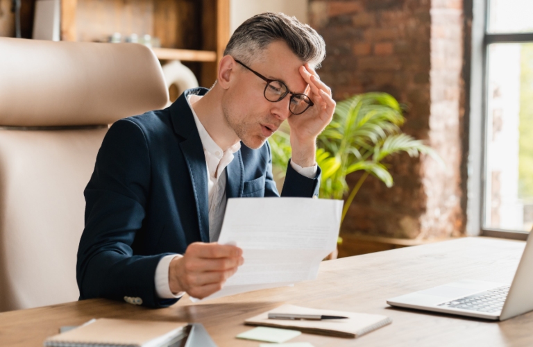 stressed man reading documents