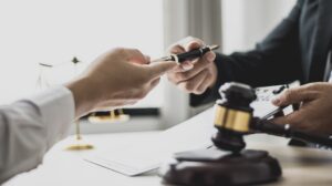 Attorney gives the client a pen to sign document